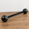 120 cm black dumbbell-shaped product on a wood floor against a white wall