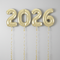 2026 Gold Helium Balloons Plain Background Ribbons Extending Off Page