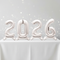 2026 Silver Standing Balloons on White Tablecloth with Silver Glitz Background