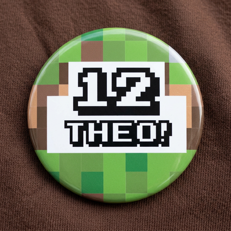 58mm Pixel Blocks badge on a brown T-shirt, in a tight square close-up with soft light and shade