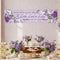 Baby shower banner with floral design and text above a table set with tea cups and sandwiches.