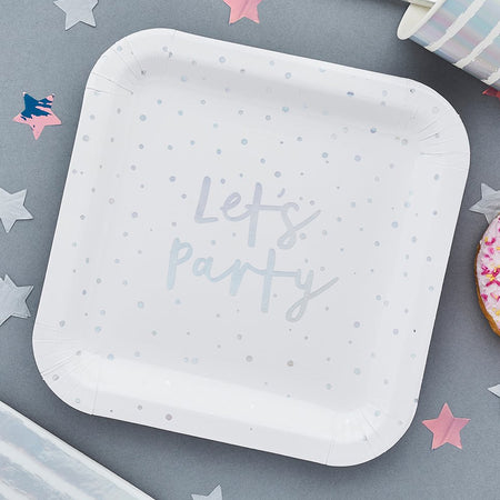 White paper plate with 'Let's Party' text on a gray surface with star decorations.