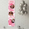 A vertical pink and white custom party banner displayed on a white brick wall, featuring customizable photos of a woman, cowboy boots, a cowboy hat, and a disco ball with text reading 'Annika's Last Rodeo', 'Bride's Last Rodeo', and 'She Found Her Cowboy'. Silver balloons and disco balls decorate the scene.