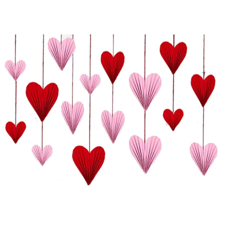 Red and pink heart-shaped decorations hanging on a white background