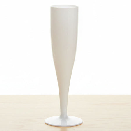 White vase on a beige surface with a white background