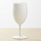 White wine glass on a light beige background