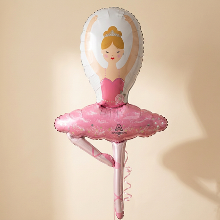 Ballerina balloon with pink curling ribbon hanging behind it, against a softly lit cream background