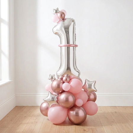 Balloon arrangement on a wood floor against a white wall, with the present and bunny removed