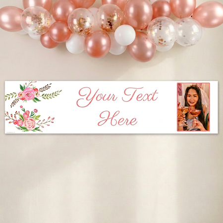 Banner on a cream wall with a close-up balloon arch extending beyond the top and both sides