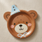 Bear party plate with a slightly darker brown finish on a beige tablecloth