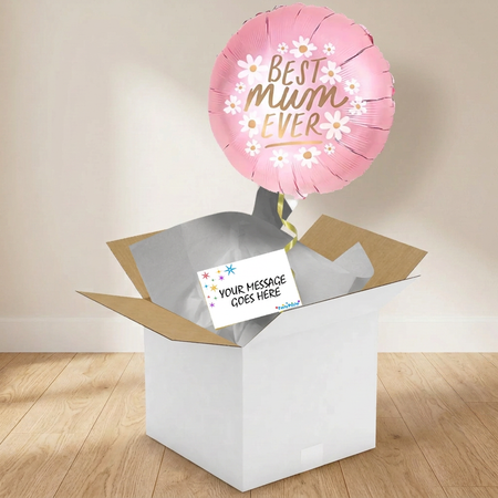 Best Mum Ever balloon and gift box on a wooden floor against a softly lit neutral wall, in square format