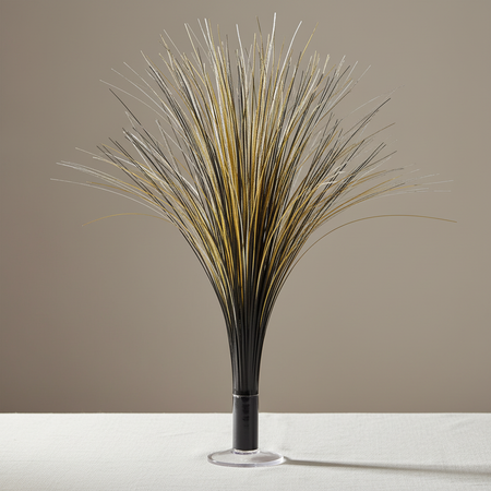 Black and gold metallic spray centrepiece on a white-clothed table