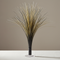 Black and gold metallic spray centrepiece on a white-clothed table