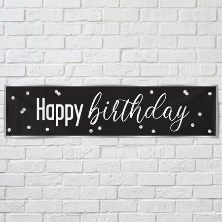Black and silver Happy Birthday banner on a white brick wall with soft light and shade, in square format