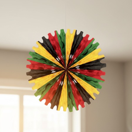 Black red green yellow paper fan hanging from ceiling close up