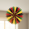 Black red green yellow paper fan hanging from ceiling close up