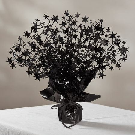Black starburst spray centrepiece on a white-clothed table