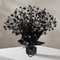 Black starburst spray centrepiece on a white-clothed table