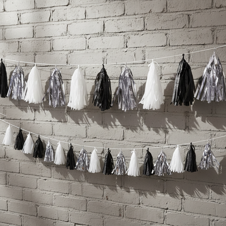 Black White Silver Tassel Bunting on Grey Brick Wall