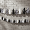 Black White Silver Tassel Bunting on Grey Brick Wall