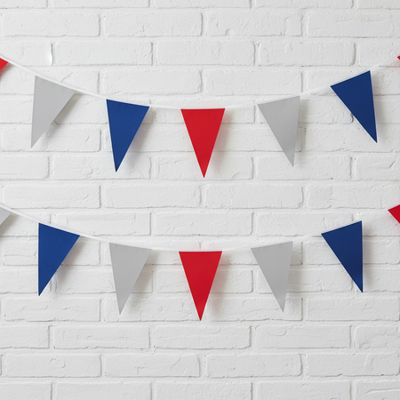 Blue Red Silver Fabric Bunting on White Brick Wall