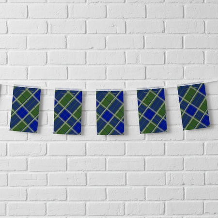 Blue tartan bunting across a white brick wall