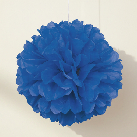 Blue tissue pom-pom on an off-white wall
