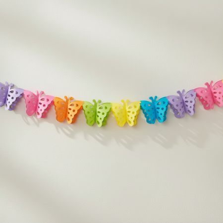 A pastel rainbow butterfly garland with colorful paper-cut butterflies strung across a plain light background.
