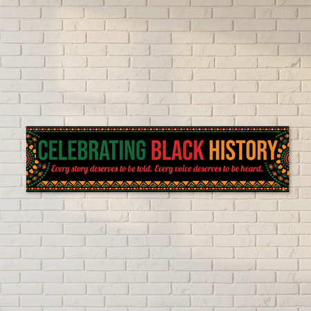 Celebrating Black History banner on white brick wall