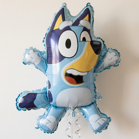 Character balloon floating with silver curling ribbon against a softly lit neutral background, close up in square format