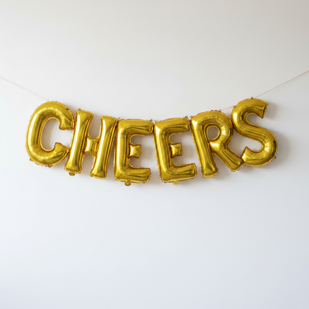 CHEERS Gold Foil Balloons Hanging Like Bunting on White Wall
