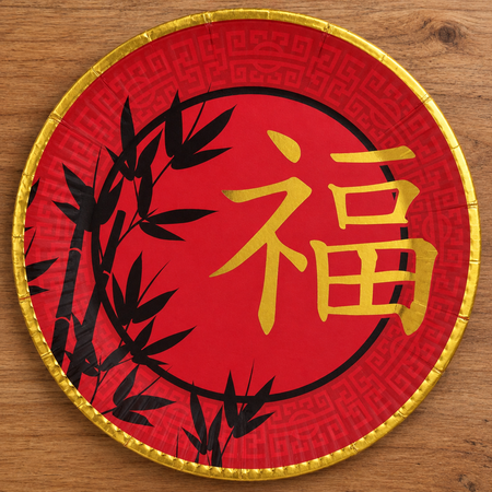 Chinese bamboo paper plate from above on a wood table, square format