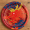Chinese dragon paper plate from above on a wood table, square format