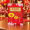 Chinese New Year menu card centred on a wood table with a blurred festive background, square format