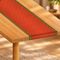 Chinese themed red table runner on a wooden table with a warm blurred background, square format
