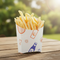 Chip scoop with fries on picnic table clean garden background