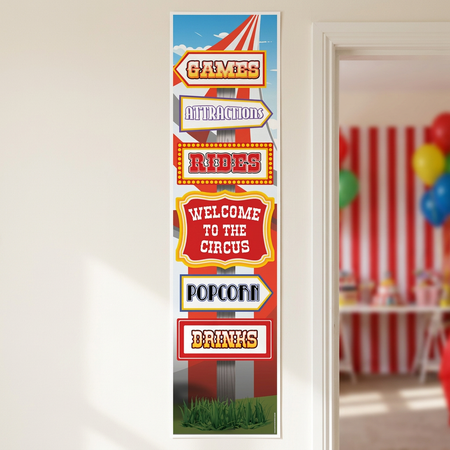Circus banner on a neutral wall beside an open doorway into a circus-themed party, with the banner in focus in square format