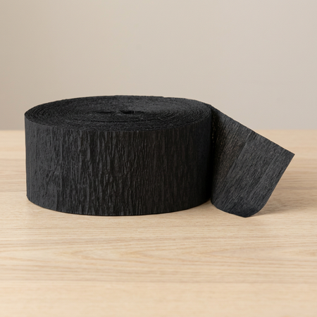 Close-up black streamer roll on a wooden table with a neutral background, in square format