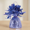 Close-up of the lavender foil balloon weight on a matching wooden table with a neutral background, in square format