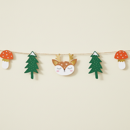 Close-up of the woodland garland against a cream wall