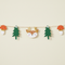 Close-up of the woodland garland against a cream wall