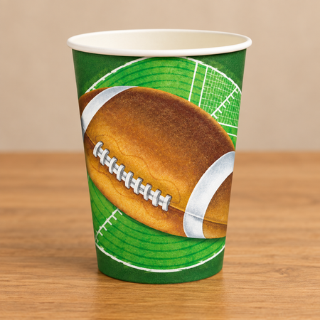 Close-up paper cup on a wooden table with a neutral background, in square format