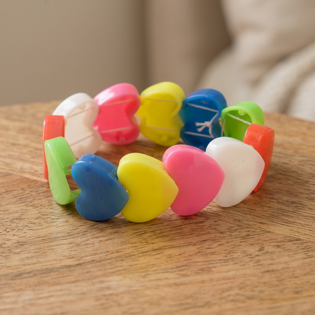 Close-up square heart bracelet image on a wooden table with a neutral background