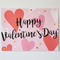 Close-up Valentine’s Day poster on a white wall with soft light and shade