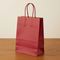 Dark Red Party Bag - Wood Table Neutral Wall