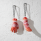 Fake severed hand and foot hanging against white textured wall
