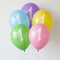 Five first birthday balloons floating with white curling ribbon against a softly lit white wall, in square format