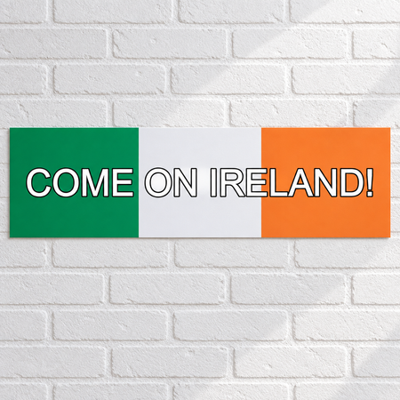Flat paper Come On Ireland banner on a white brick wall, with soft light and shade in square format