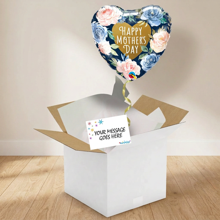 Floral Mother’s Day balloon and gift box on a wooden floor against a softly lit neutral wall, in square format