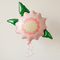 Flower balloon floating with pink curling ribbon against a neutral background with soft light and shade, in square format